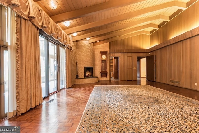 interior space featuring wood walls, wood ceiling, a fireplace, dark parquet flooring, and high vaulted ceiling