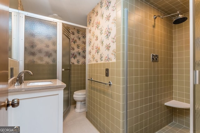 bathroom featuring vanity, toilet, an enclosed shower, and tile patterned flooring