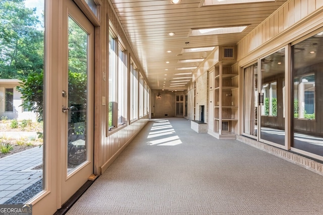 unfurnished sunroom with a skylight and plenty of natural light