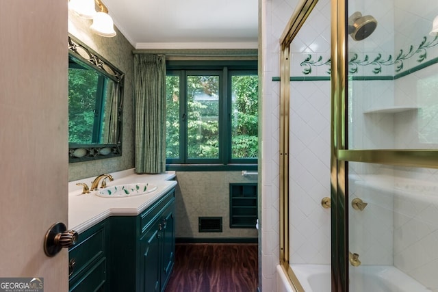 bathroom featuring vanity, tiled shower / bath, hardwood / wood-style floors, and tile walls