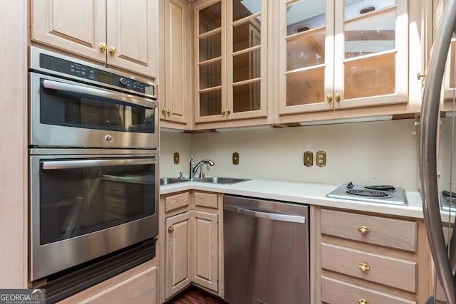 kitchen with sink, appliances with stainless steel finishes, and light brown cabinets