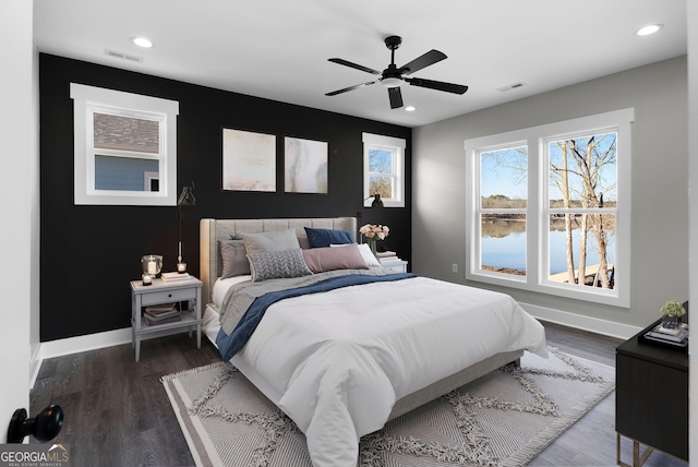 bedroom with dark wood-type flooring, visible vents, and baseboards