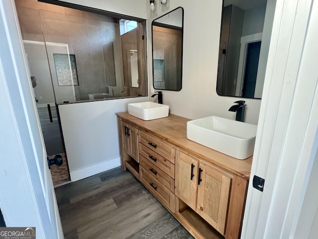 bathroom featuring a shower, vanity, and wood-type flooring