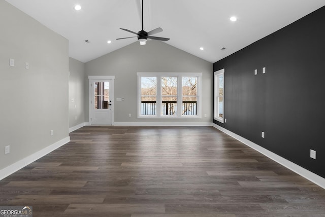 unfurnished living room featuring high vaulted ceiling, baseboards, dark wood-style flooring, and recessed lighting