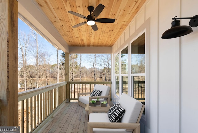 sunroom featuring wooden ceiling, a healthy amount of sunlight, and ceiling fan