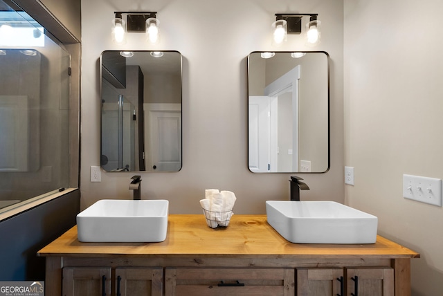 bathroom with a sink and double vanity