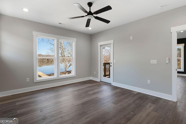 unfurnished room featuring baseboards, visible vents, and a healthy amount of sunlight