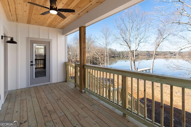 wooden deck featuring a water view and a ceiling fan