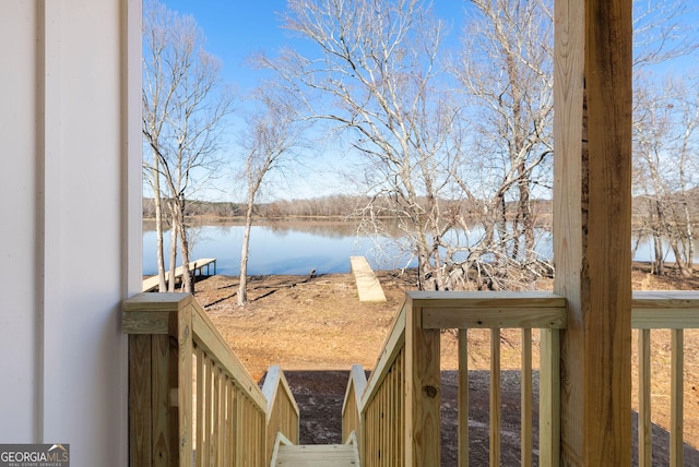 exterior space with a dock and a water view