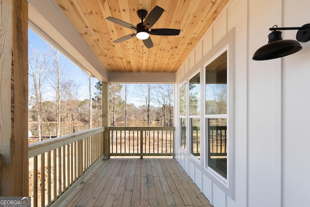 unfurnished sunroom with a healthy amount of sunlight, wood ceiling, and ceiling fan