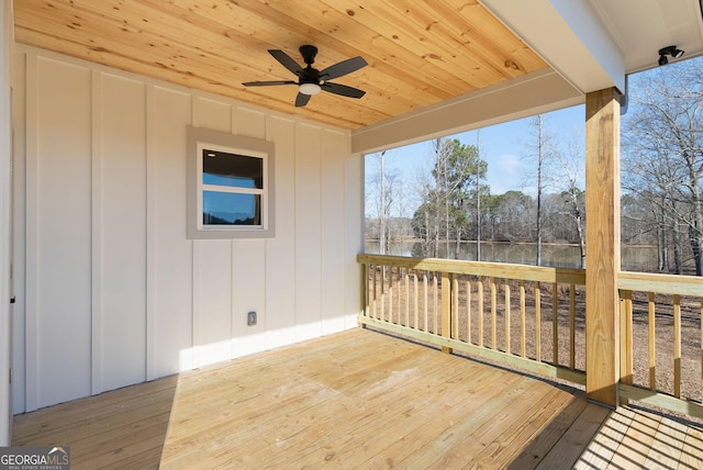 wooden terrace featuring a ceiling fan