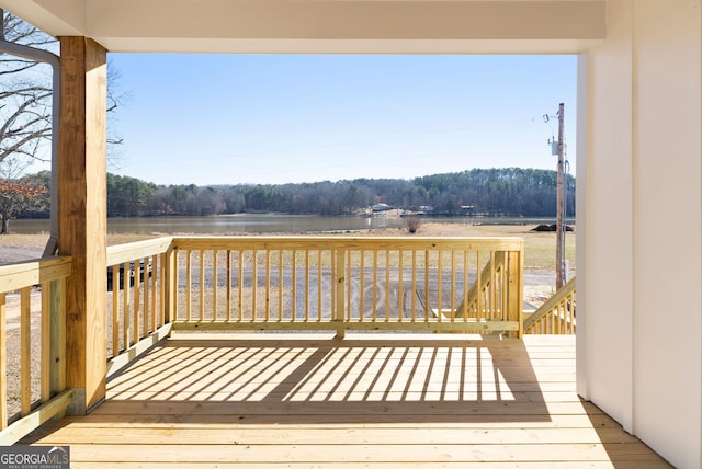 wooden deck featuring a water view