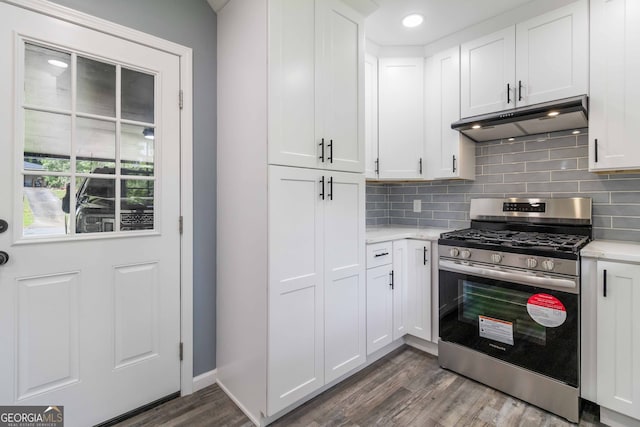 kitchen with stainless steel range with gas cooktop, tasteful backsplash, white cabinets, and hardwood / wood-style floors