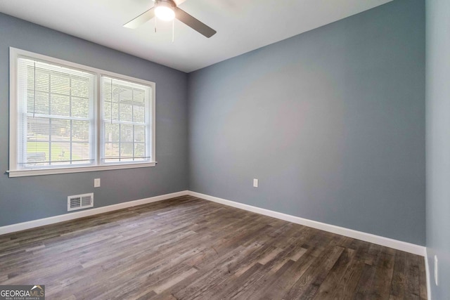 unfurnished room featuring dark hardwood / wood-style floors and ceiling fan