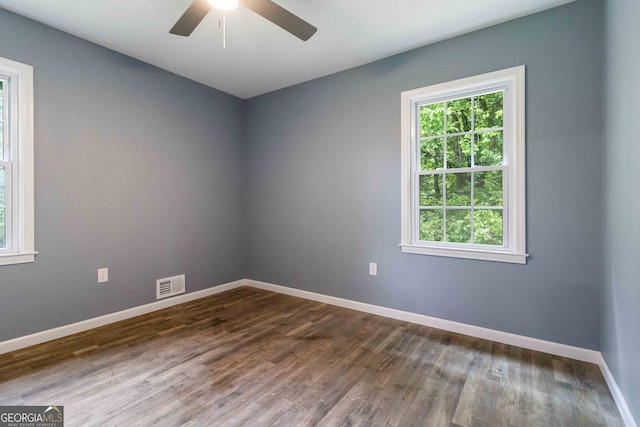 empty room featuring ceiling fan and dark hardwood / wood-style floors