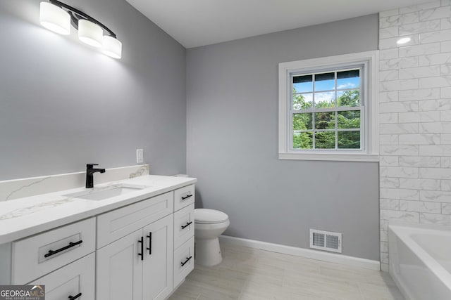 bathroom featuring tile patterned floors, vanity, and toilet