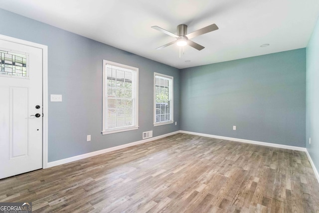 foyer with hardwood / wood-style flooring and ceiling fan