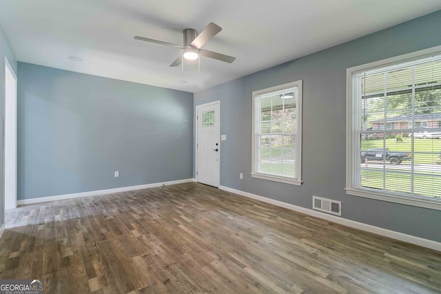 spare room with dark hardwood / wood-style flooring and ceiling fan