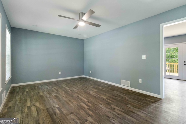 unfurnished room featuring ceiling fan, french doors, and dark hardwood / wood-style flooring