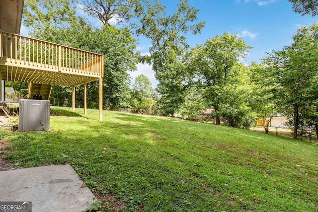 view of yard featuring central AC and a wooden deck