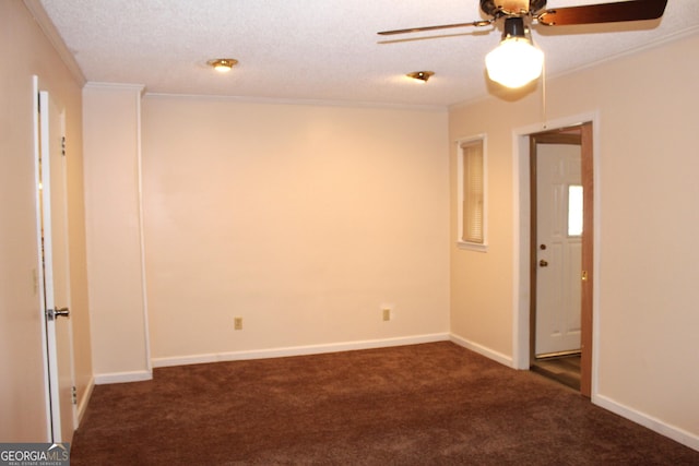 spare room featuring ceiling fan, crown molding, a textured ceiling, and dark colored carpet