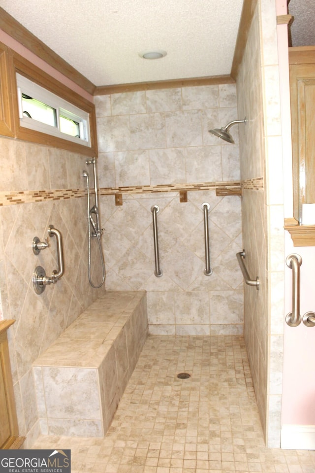 bathroom with a textured ceiling and walk in shower