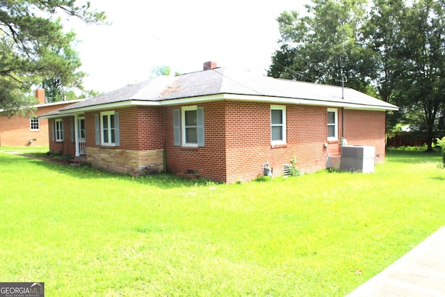 exterior space with a front yard and central air condition unit