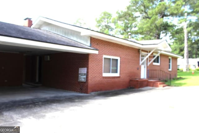 exterior space featuring a carport