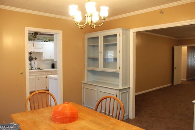 carpeted dining space featuring crown molding and a chandelier