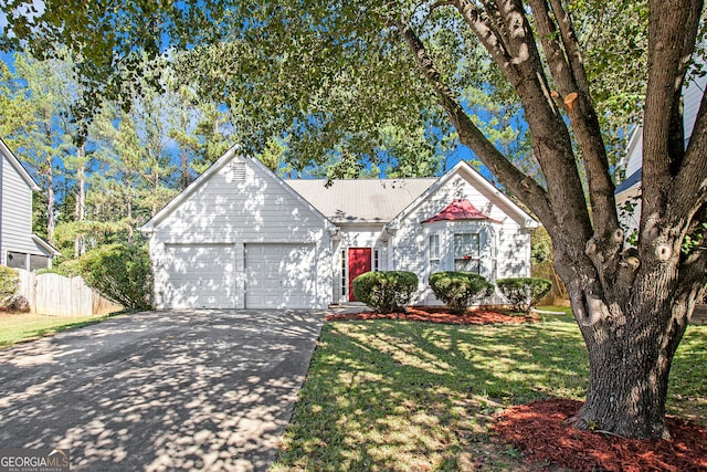 view of front of home with a garage and a front lawn