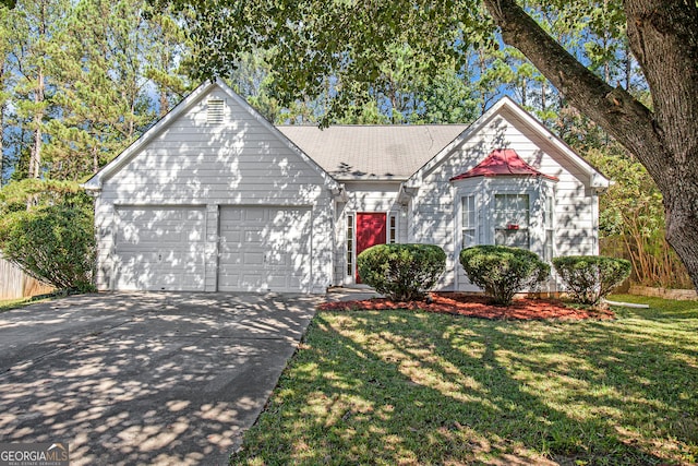 tudor house with a garage and a front yard