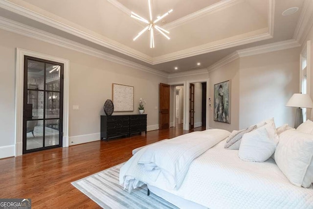 bedroom featuring a raised ceiling, an inviting chandelier, crown molding, dark hardwood / wood-style flooring, and access to exterior