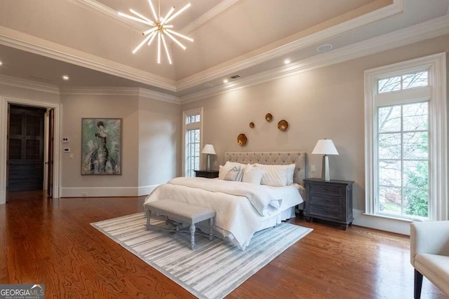 bedroom with a raised ceiling, an inviting chandelier, crown molding, and dark wood-type flooring