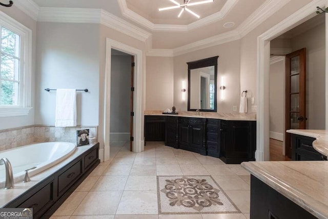 bathroom featuring ornamental molding, a bathtub, tile patterned flooring, and a raised ceiling