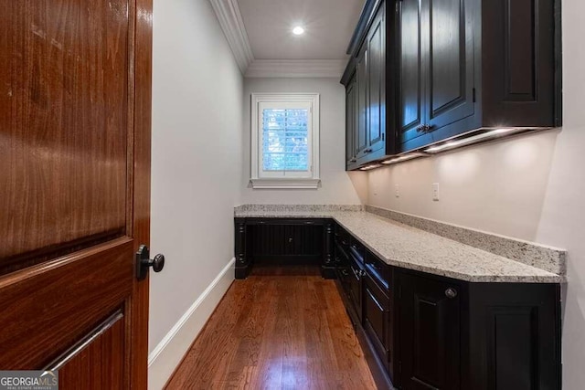 interior space with dark hardwood / wood-style flooring and crown molding