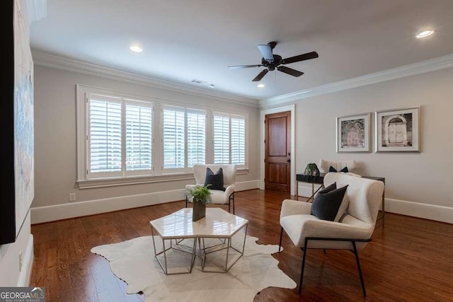 sitting room featuring ornamental molding, ceiling fan, and dark hardwood / wood-style floors