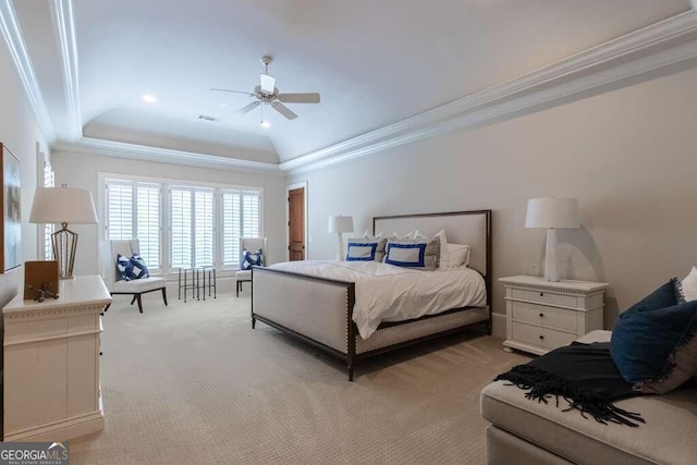 carpeted bedroom with ceiling fan, ornamental molding, and a tray ceiling