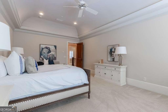 bedroom featuring light colored carpet, ceiling fan, ornamental molding, and a tray ceiling