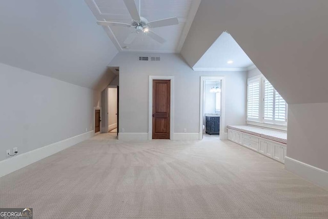 additional living space featuring ceiling fan, vaulted ceiling, and light colored carpet