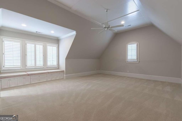 additional living space with ceiling fan, light colored carpet, and lofted ceiling