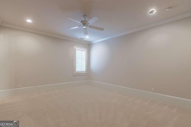 carpeted spare room featuring ornamental molding and ceiling fan