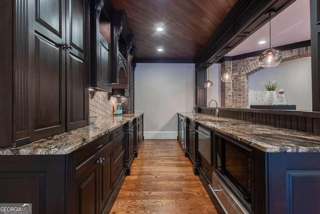 kitchen with wooden ceiling, light wood-type flooring, pendant lighting, decorative backsplash, and sink