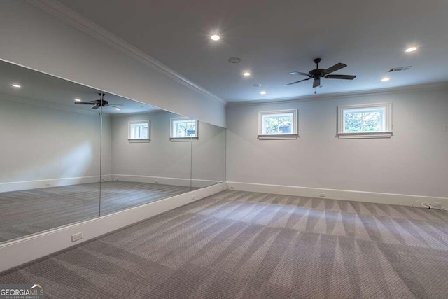 interior space with ceiling fan, ornamental molding, and carpet