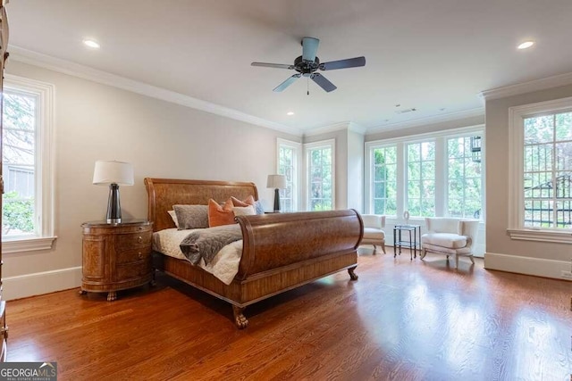 bedroom with ceiling fan, crown molding, and wood-type flooring