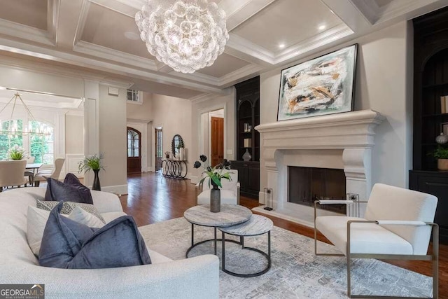 living room featuring a chandelier, hardwood / wood-style floors, beamed ceiling, ornamental molding, and coffered ceiling