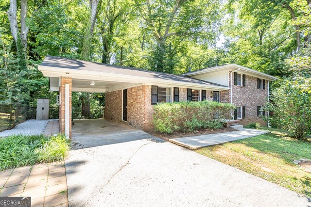 split level home featuring a carport and a shed