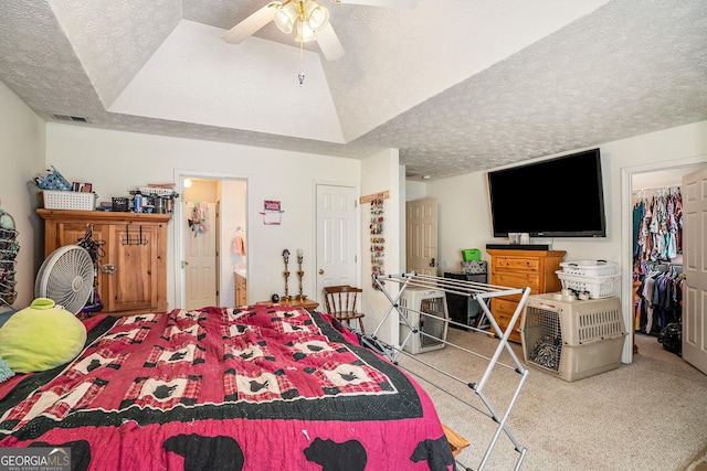 bedroom featuring ceiling fan, a textured ceiling, connected bathroom, carpet floors, and a closet