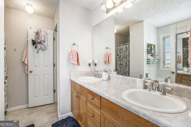 bathroom with vanity and a textured ceiling