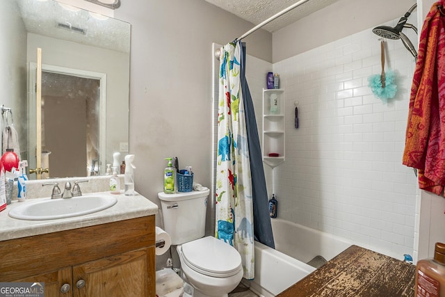 full bathroom with vanity, shower / bath combination with curtain, a textured ceiling, and toilet