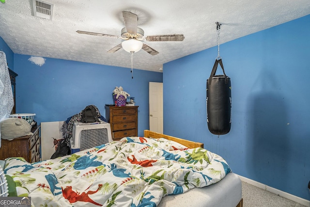 bedroom with carpet, a textured ceiling, and ceiling fan